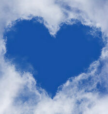 Blue sky with white clouds that are making the shape of a heart. 