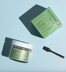 A chlorophyll mask jar with a green label with the cocokind box packaging next to it.