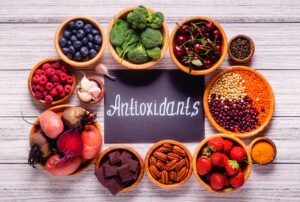 Bowls of high antioxidant foods with the word antioxidants written in the middle of them.