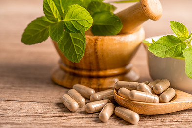 Supplement capsules with a mortar and pestle.