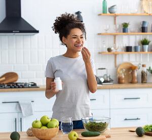 A woman taking a nutritional supplement.